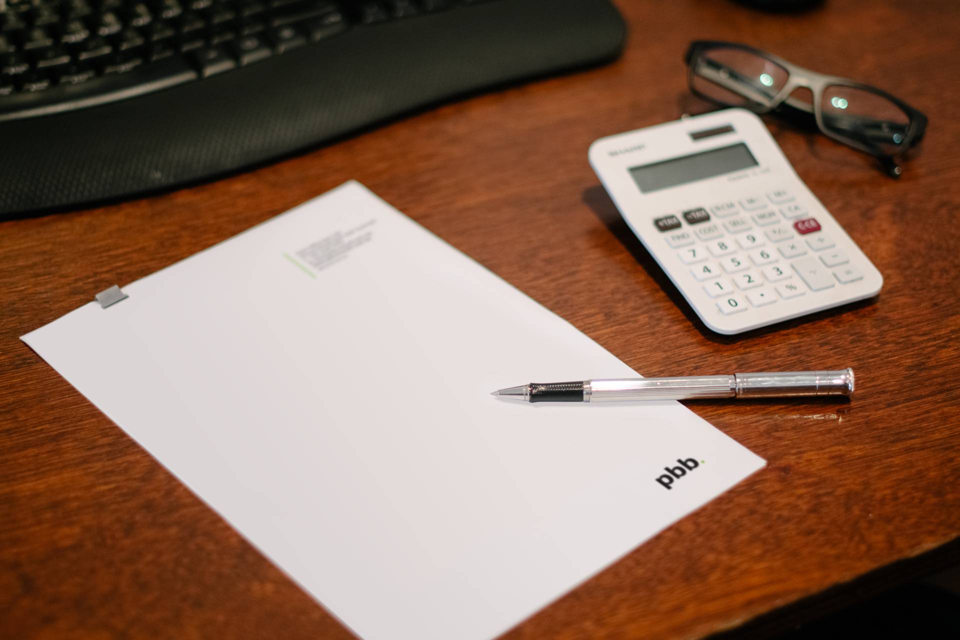 Pbb Consult Noosa Letterhead Pen And Calculator On Desk In Office 3